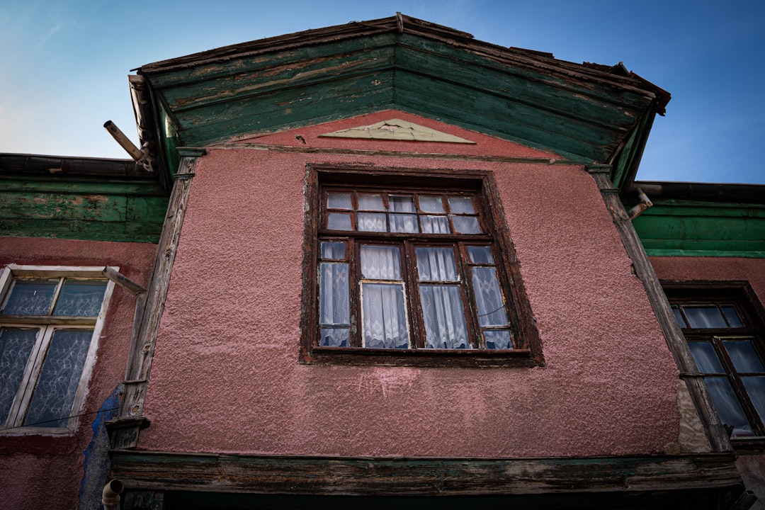 Close-up of an old, weathered pink building facade.